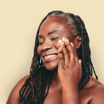 smiling female using all-natural body butter made with premium essential oils | herb'neden