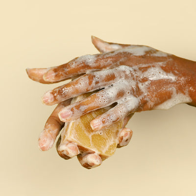 hands washing with tea tree & turmeric bar soap | herb'neden